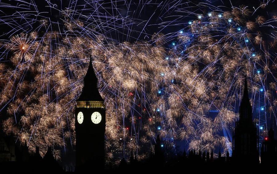 Fireworks explode around London landmarks.