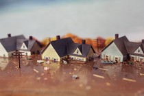 Three suburban houses submerged in floodwater