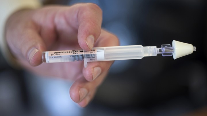 Police Detective Lt. Patrick Glynn holds a nasal injection containing naloxone in 2014.