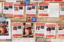 A photo of a pinboard where people have posted details of relatives taken hostage by Hamas.