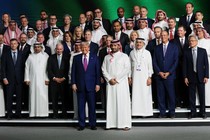 Trump poses with Saudi Crown Prince Mohammed bin Salman and business leaders in Riyadh on May 13.