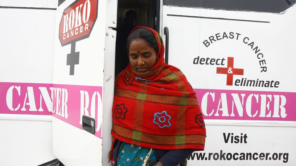 A woman exits a mobile cancer-detection unit in Chandigarh, India.