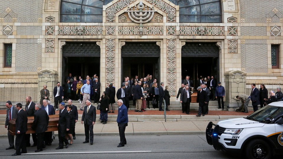 Mourners carry the caskets of two victims killed in an attack on the Tree of Life synagogue.