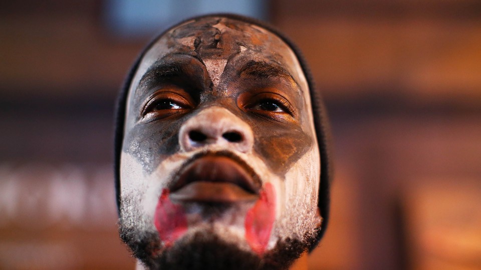 A black man with a painted face