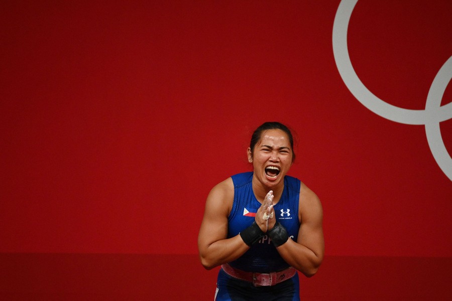 A weightlifter celebrates her win.