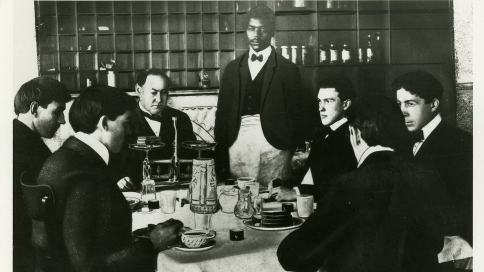 A black-and-white photo of Harvey Wiley and members of the "Poison Squad" eating a meal