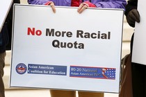 A sign says "No More Racial Quota"