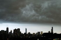 The Chicago skyline under a dark cloud