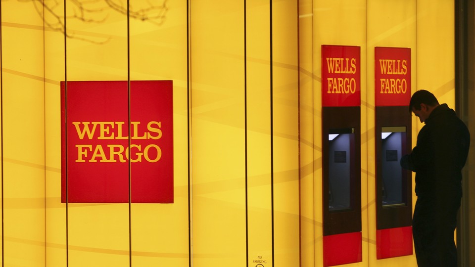 A man uses a Wells Fargo ATM.
