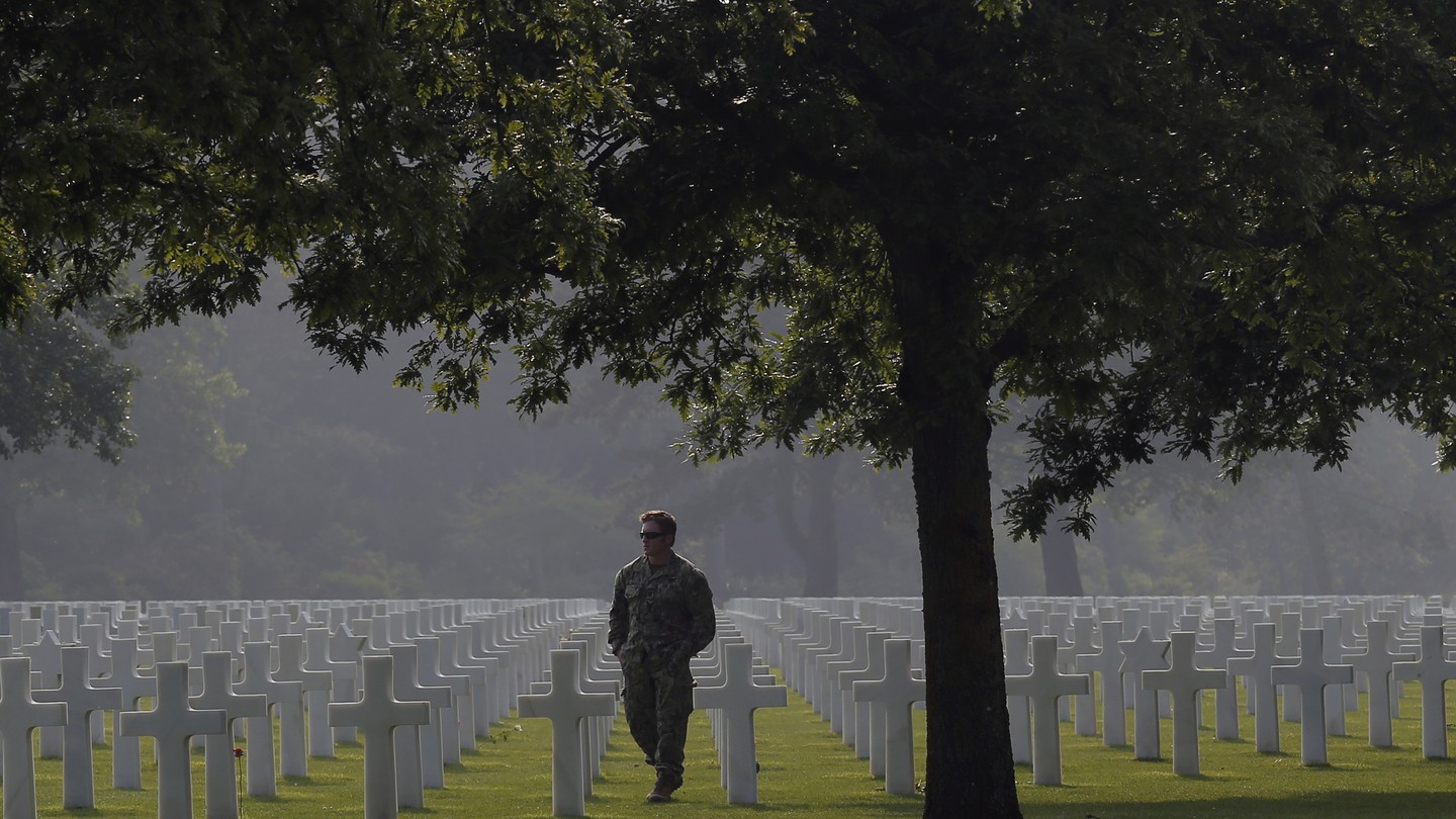 An American soldier walks in the Normandy American Cemetery on June 5, 2016.