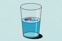 A glass filled halfway with blue liquid. An "I Voted" sticker floats at the top.