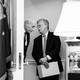 Former White House Chief of Staff John Kelly talks to ex–National Security Adviser John Bolton in a doorway of the White House. President Donald Trump is seen speaking off to the side.