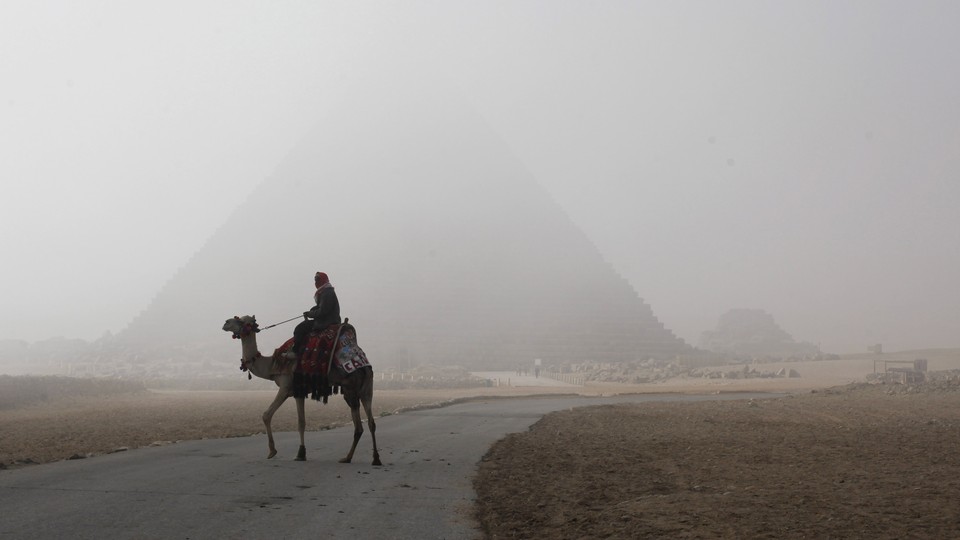 A photograph of a person riding a camel