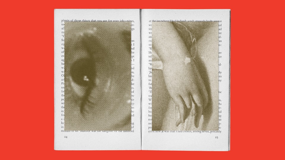 open book with images of an eye and a hand juxtaposed on top of the pages