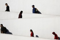 People going up an inclined zigzag pathway