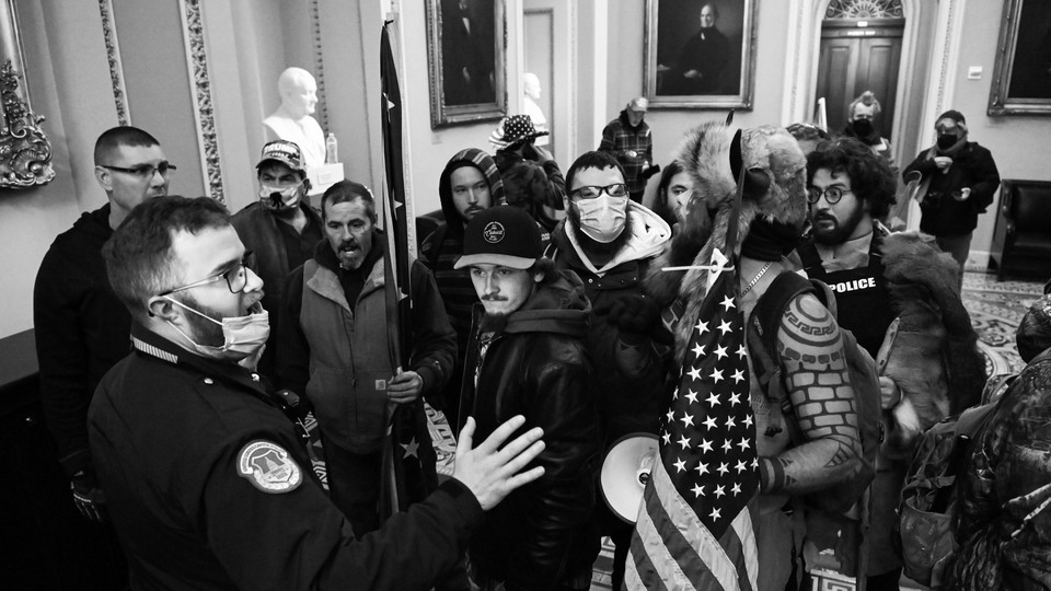 A police officer talking to insurrectionists