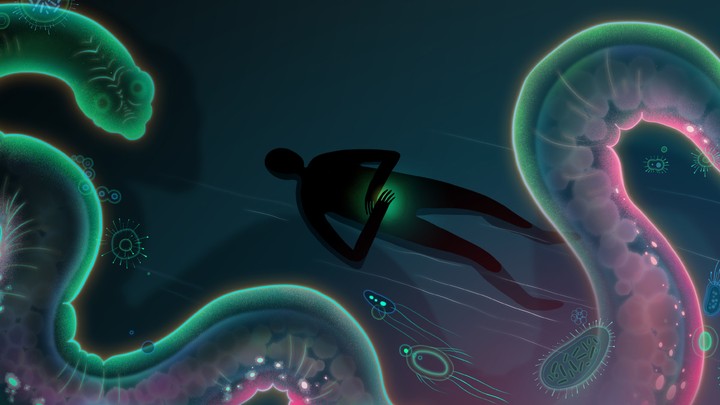 A silhouette of a person next to a giant, glowing worm