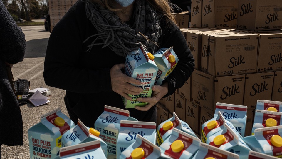 A volunteer prepares food to be delivered during a food distribution for casino workers laid off due to the coronavirus pandemic at the Harbor Square Mall in Egg Harbor Township, New Jesery.