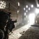 An American soldier points his rifle at a doorway after coming under fire by the Taliban while on patrol in Kandahar province in April 2012.