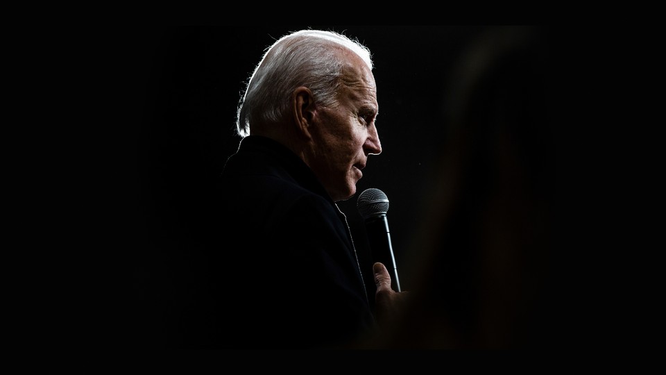 A photo of Biden speaking into a microphone