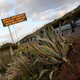 A highway sign that reads, "water rationing started—expect interruptions"
