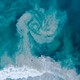 Rip tide forming a whirlpool of sand.