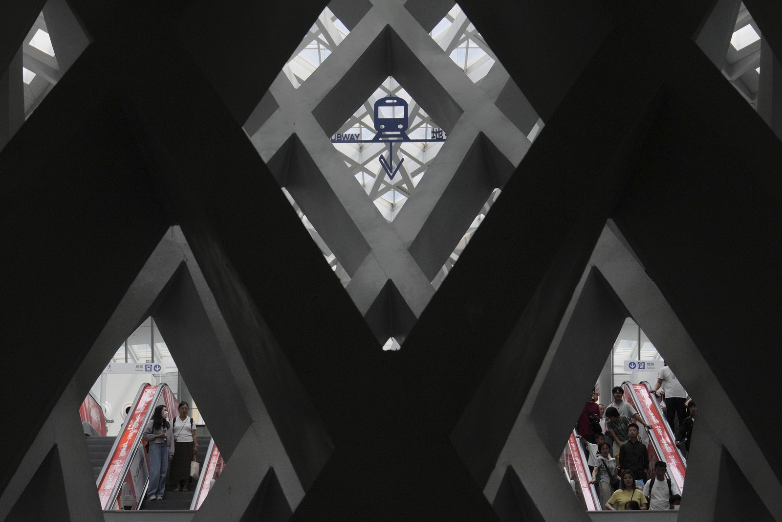 An interior view of a large angular public art installation inside an airport.