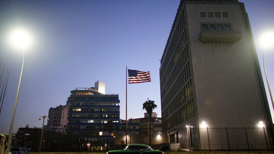 A car drives past the U.S. Embassy in Havana