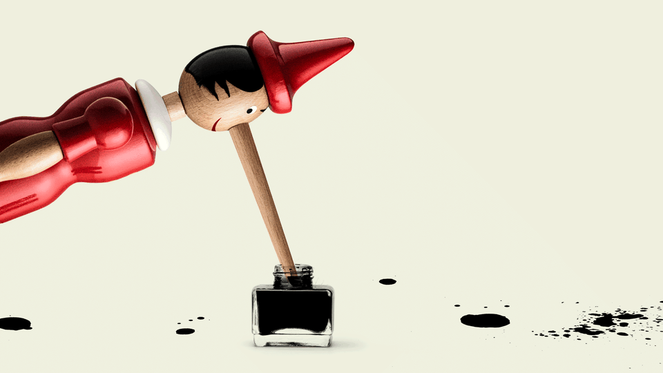 A long-nosed Pinocchio figure dipping his nose in a pot of ink