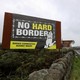 A billboard erected at the Irish border reads "No hard border: Border Communities Against Brexit."