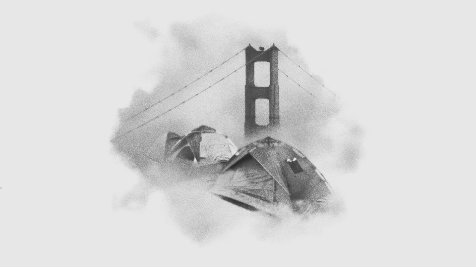 A black-and-white image shows a bit of the Golden Gate Bridge through fog, with two tents with some patches on top in front.