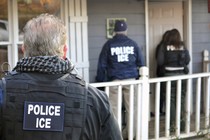 Police officers wearing ICE vests and jackets