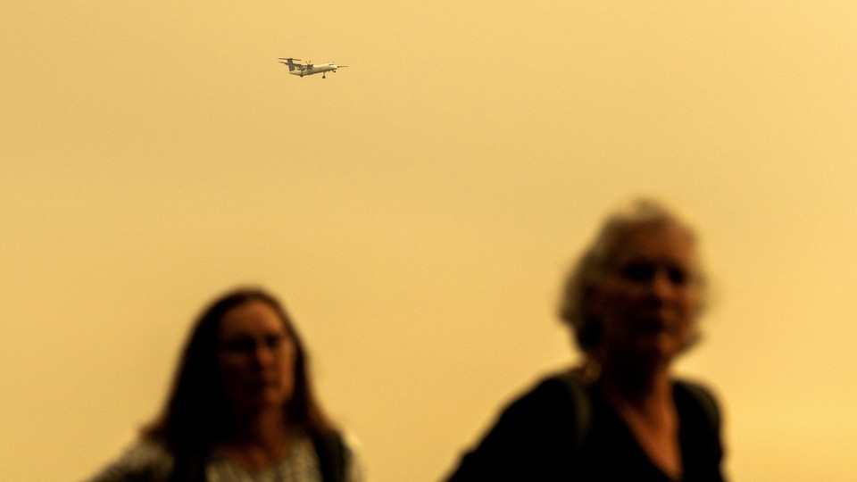 Two women pictured against hazy orange sky