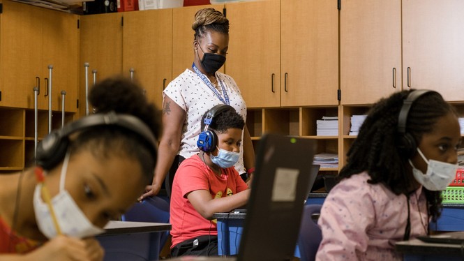 Tonette McQueen helps Zion Graham, 8, with a summer school assignment at Hunter Elementary in Greensboro, North Carolina., July 19, 2021.
