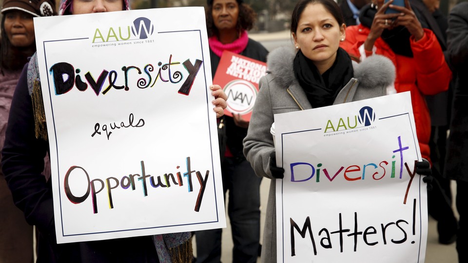 Demonstrators outside the Supreme Court hold signs advocating for diversity.