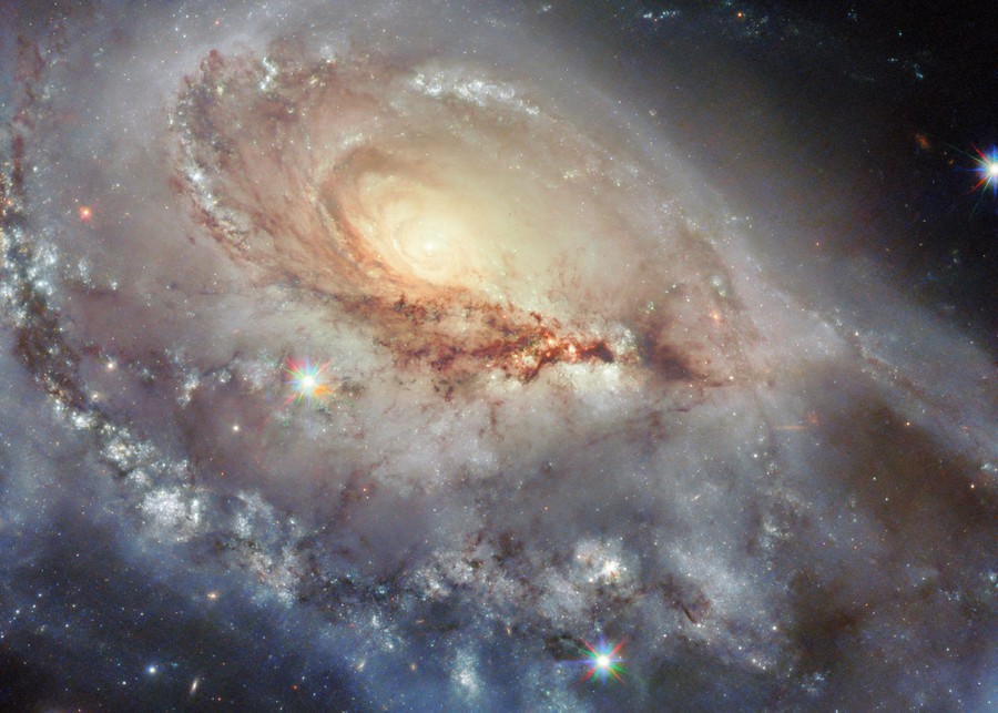 A spiral galaxy seen in detail, including an apparently larger "arm" stretched out toward the observer