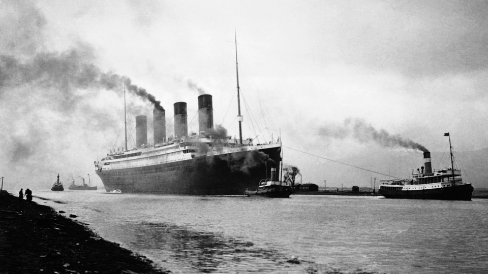 A black-and-white photograph depicting the Titanic departing for a sea trial