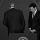 Donald Trump flanked by aides at a press conference