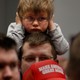 Child covers his ears during a Trump campaign rally
