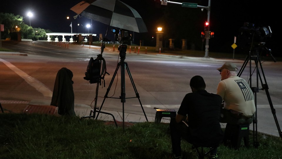 Media wait at the front gate of U.S. Army base Fort Leavenworth for the expected departure of Chelsea Manning in Leavenworth, Kansas, on May 17.