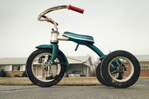 A tricycle in front of a house