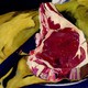 A painting of a steak with a yellow background