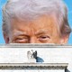 Illustration of Donald Trump’s head peering over the roof of the Federal Reserve building