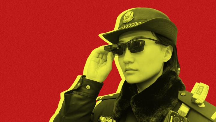 A police officer wearing a pair of "smart glasses" with a facial-recognition system at Zhengzhou East Railway Station in China