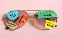 Sunglasses covered in brand tags and price stickers