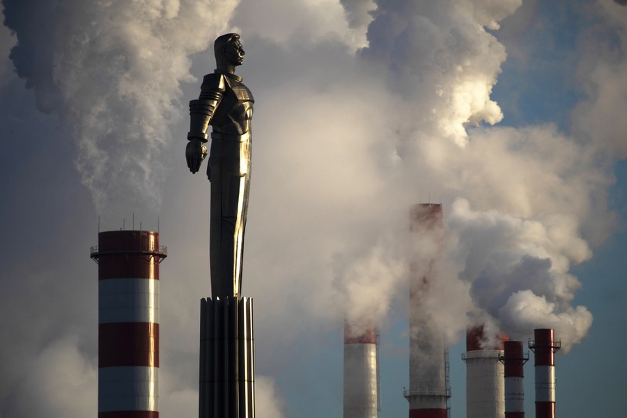 Steam rises from a heating plant behind a monument to Soviet cosmonaut Yuri Gagarin.