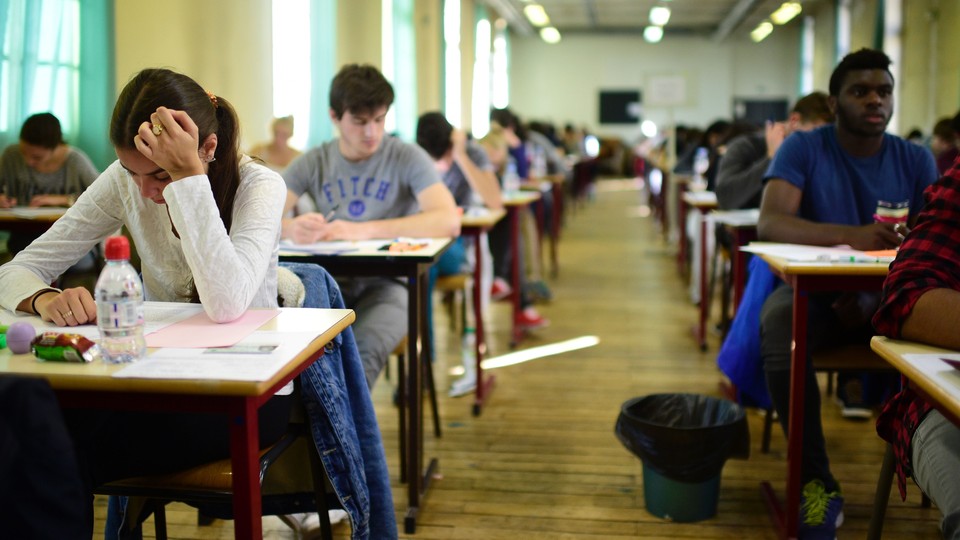 Students take an exam in class.