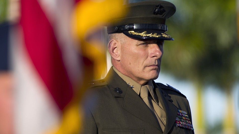 John Kelly, in uniform, stands at attention during the Southern Command change-of-command ceremony in 2012, in Miami.