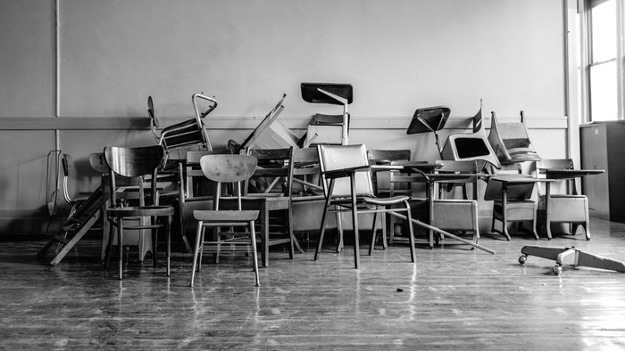 Chairs stacked in a classroom.