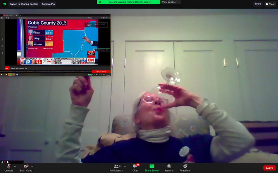 woman drinking wine and pointing to Georgia election map